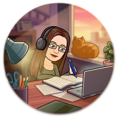 woman wearing headphones and writing at a desk and orange cat sitting at a window nearby